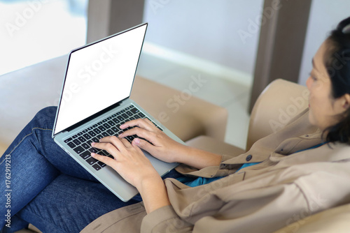 A laptop, a woman hands typing on the keyboard, writing articles, browsing social media, and managing an online business