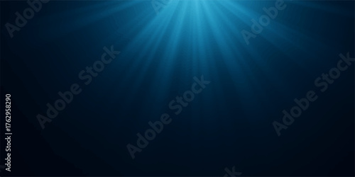 Bright sun rays burst through the dark blue background, an abstract glow of light underwater