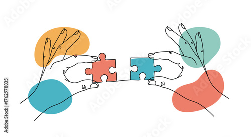 Two hands connecting puzzle pieces symbolizing teamwork and collaboration.