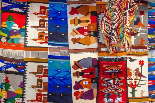 Colorful traditional wool rugs and blankets with Andean designs are sold at the Plaza de los Ponchos artisan market in Otavalo, Imbabura Province, Ecuador	