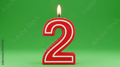 3D rendered birthday candle shaped like the number 2 in red and white with a lit flame. The green screen is perfect for chroma key compositing in anniversary, celebration, or age two videos.