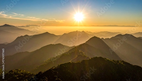 Fototapeta Naklejka Na Ścianę i Meble -  Scenic mountaintops bathed in golden sunlight at dawn