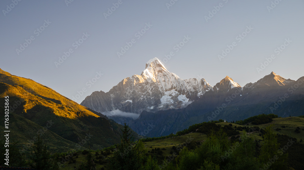 Fototapeta premium Sunrise over Mount Siguniang – Golden Peaks in Sichuan, China