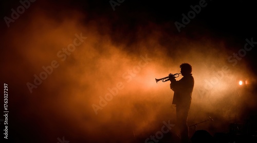 Musician playing trumpet in smoke on stage