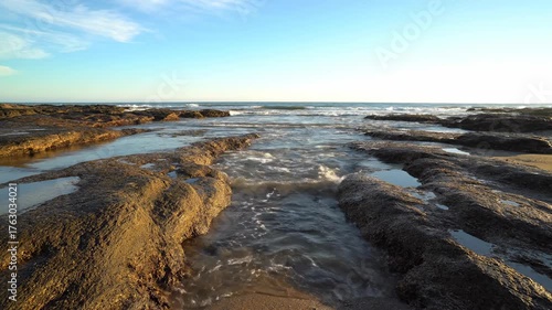 Coastal Majesty: The tranquil embrace of the ocean's edge unfolds, capturing the raw beauty of rugged cliffs where sea meets the sky. 