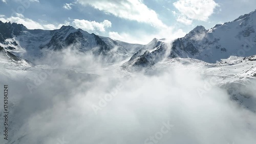 Aerial of snowy mountain range with snow
