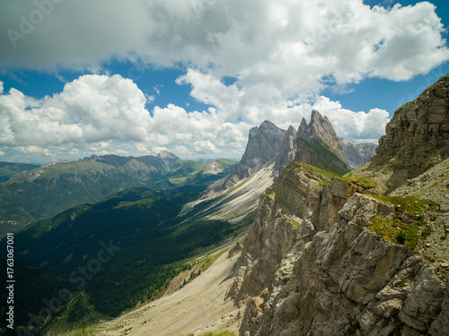 Spectacular view of Seceda ridgeline in the Dolomites, Italy. Dramatic limestone peaks rising above vibrant green slopes under a bright summer sky — a breathtaking natural masterpiece.