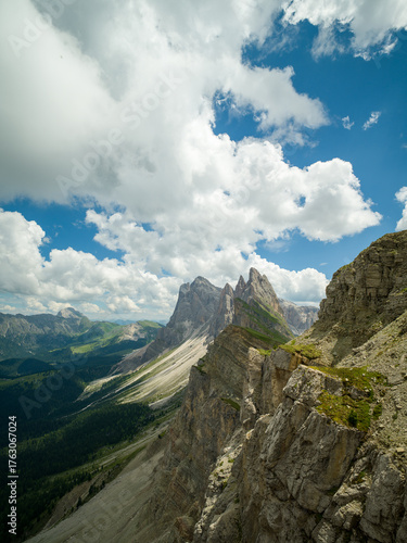 Spectacular view of Seceda ridgeline in the Dolomites, Italy. Dramatic limestone peaks rising above vibrant green slopes under a bright summer sky — a breathtaking natural masterpiece.