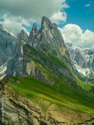 Spectacular view of Seceda ridgeline in the Dolomites, Italy. Dramatic limestone peaks rising above vibrant green slopes under a bright summer sky — a breathtaking natural masterpiece.