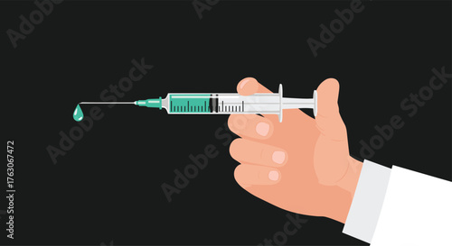 Hand holding syringe with green liquid and drop falling.
