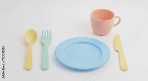Colorful toy tableware set for children's playtime, featuring a pastel plate, cup, and cutlery arranged for an imaginative meal