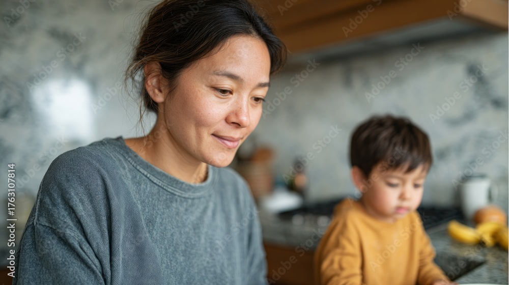 Obraz premium Woman and child cooking together in kitchen.