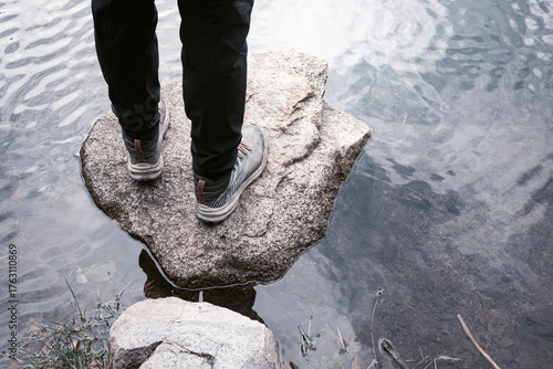 Hiker standing on a stone