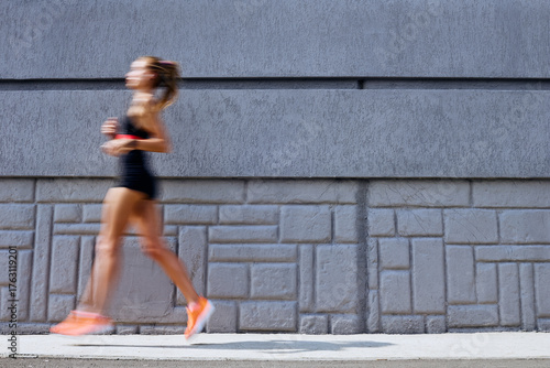 Woman jogging outdoors, motion concept