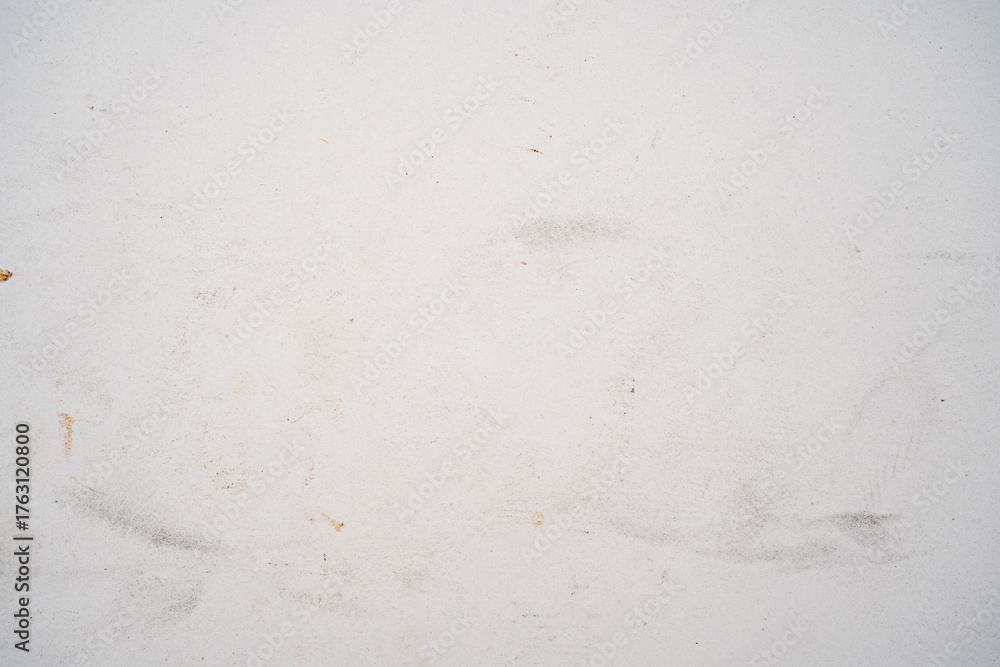 Fototapeta premium A textured white surface with faint scratches and marks.