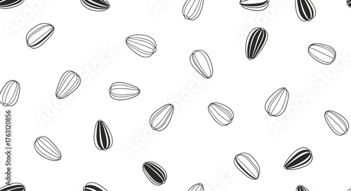 A seamless pattern of black and white sunflower seeds scattered on a white background surface view