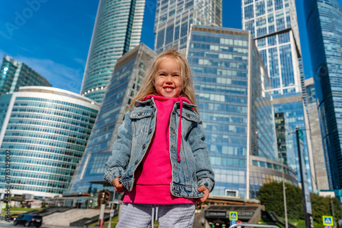Photography Child girl in front of the skyscrapers of Moscow City in summer.