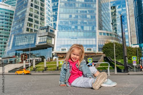 Photography Child girl in front of the skyscrapers of Moscow City in summer.