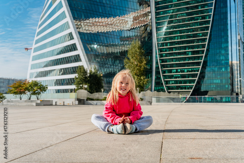 Photography Child girl in front of the skyscrapers of Moscow City in summer.