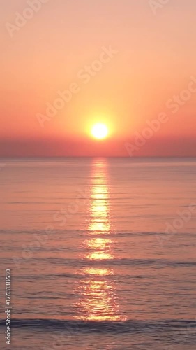Serene Ocean Sunrise with Golden Sun Reflecting on Calm Water