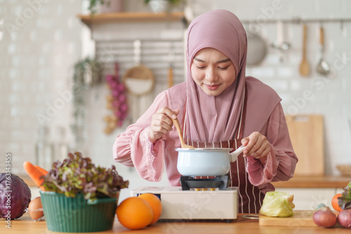 muslim woman in hijab prepare fresh vegetables and fruits to cook healthy food in the modern kitchen