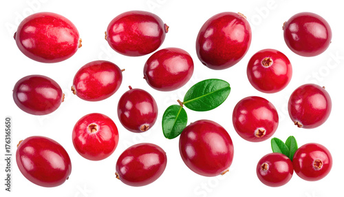Scattered cranberries and green leaves on a black background offer a vibrant, fresh, and natural aesthetic