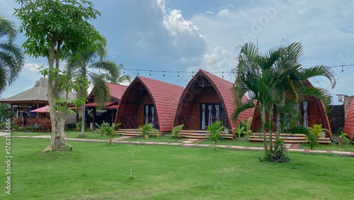 Tropical Unique Villa with Funnel Design, Surrounded by Greenery and a Clean Pool with Garden Seats. 