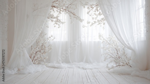 Bright, minimalist interior with sheer curtains, white wooden floor, and decorative white floral branches creating an elegant ambiance.