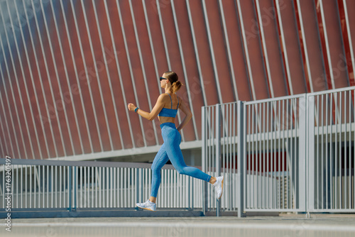 Running outdoors in modern sportswear at a sunny location