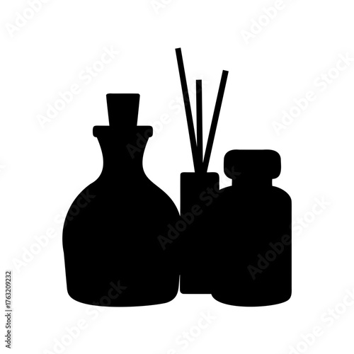 A silhouette of essential oil diffuser bottles and diffuser sticks for aromatherapy