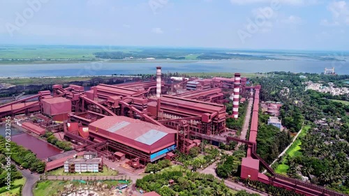 Colorful iron ore transshipment. Aerial view of iron ore processing factory in India. Factory process iron ore into steel 4K.