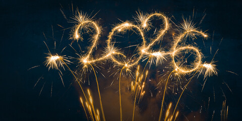 happy new year, new year's eve, silvester, new years eve, sparklers celebration greeting card, new year card - Year 2026 in sparkler font and firework fireworks pyrotechnic, blue night sky background