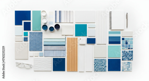 An overhead shot of blue and white tiles, paint samples, and design elements arranged on a white background, isolated on white background