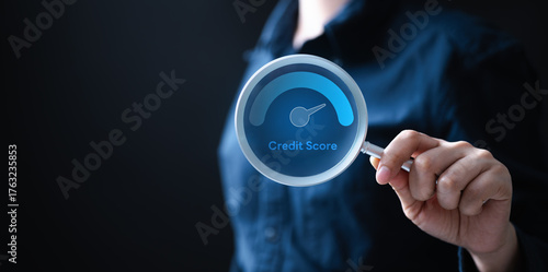 Cuadro en lienzo A person holding a magnifying glass showing a digital credit score gauge, symbolizing financial monitoring, debt management, and the importance of maintaining a healthy credit history