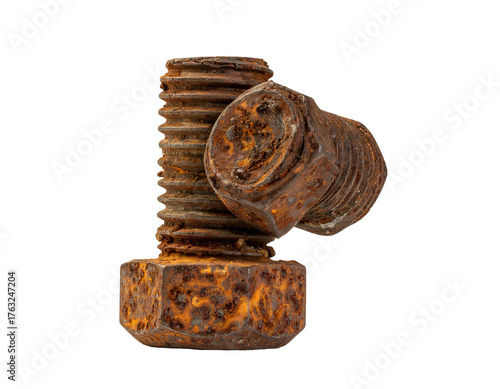 Close-up of two rusty metal bolts, one standing and the other leaning