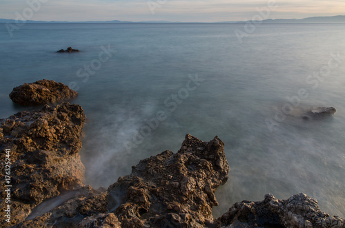 Принти на полотні Long exposure of waves around the rocks at sunset, Mediterranean, Greece
