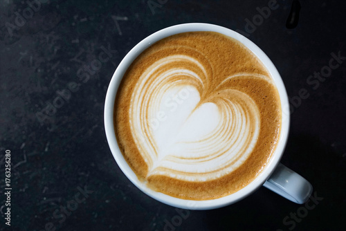 Top view of Latter art coffee on black table background.     