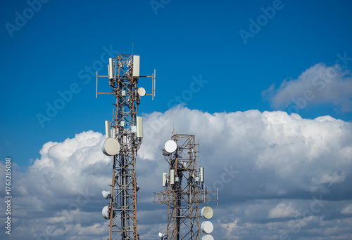 Telecommunication Towers with Antennas Under Blue Sky
