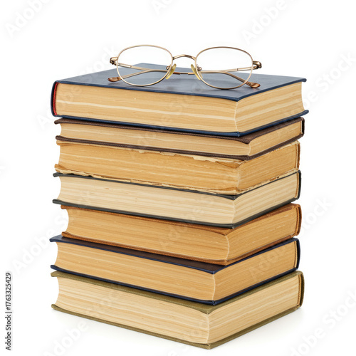 A stack of books with blue covers and tan pages with eyeglasses resting on top book