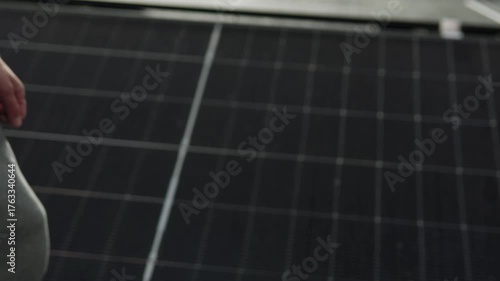 Handshake over solar panels, symbol of partnership in renewable energy.