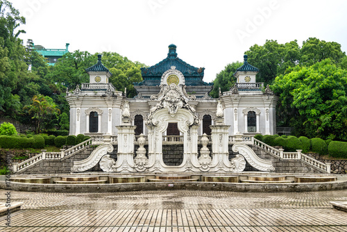 Stunning traditional building stands amid lush greenery in New Yuan Ming Palace