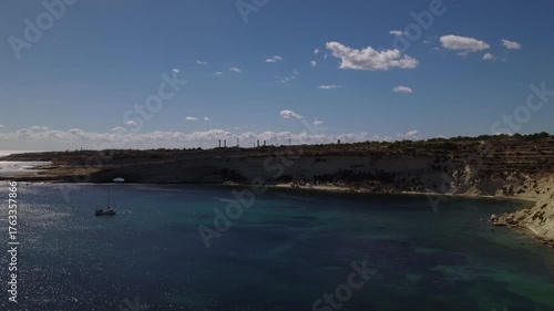 AERIAL drone shot: Limestone Wall of Ta Kalanka Sea Cave Bay with Turquoise Color Sea