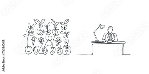 Man at desk with desk lamp and potted plants