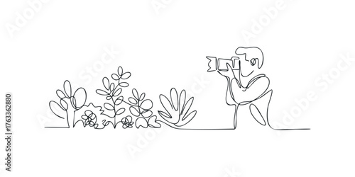 Photographer with Camera Capturing Lush Green Foliage