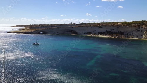 AERIAL drone shot: Limestone Wall of Ta Kalanka Sea Cave Bay with Turquoise Color Sea