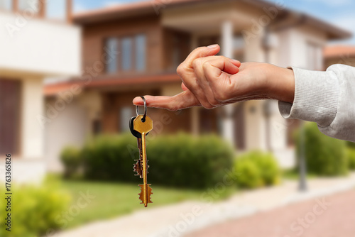 Celebrating the moment of receiving house keys in front of a charming new home