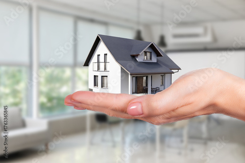 Buying a new house with confidence while holding keys in hands in a modern interior