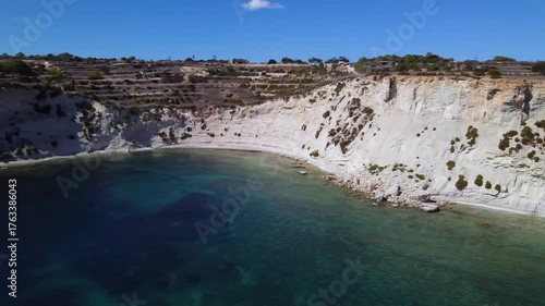 AERIAL drone shot: Limestone Wall of Ta Kalanka Sea Cave Bay with Turquoise Color Sea