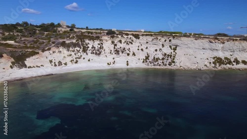 AERIAL drone shot: Limestone Wall of Ta Kalanka Sea Cave Bay with Turquoise Color Sea