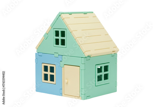 Isolated Small toy house, made of plastic blocks, blue and green structure with yellow roof